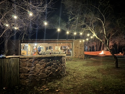 Cowley Safaris camp bar and fire illuminated at night