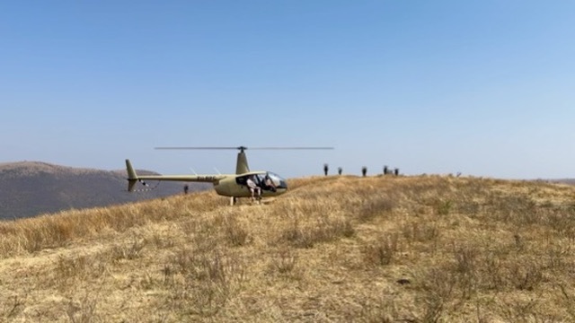 Helicopter arriving on the Cowley Safaris property